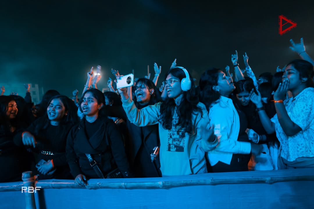 Hands up through the night — real attendees, real footfall.