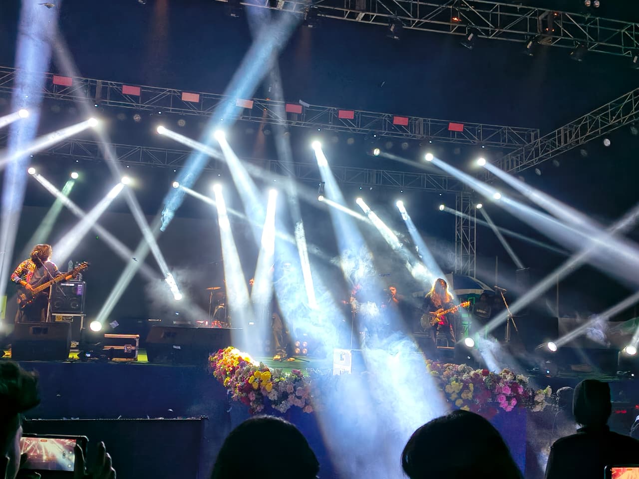 Truss-mounted lighting, haze and floral stage dressing on the night.